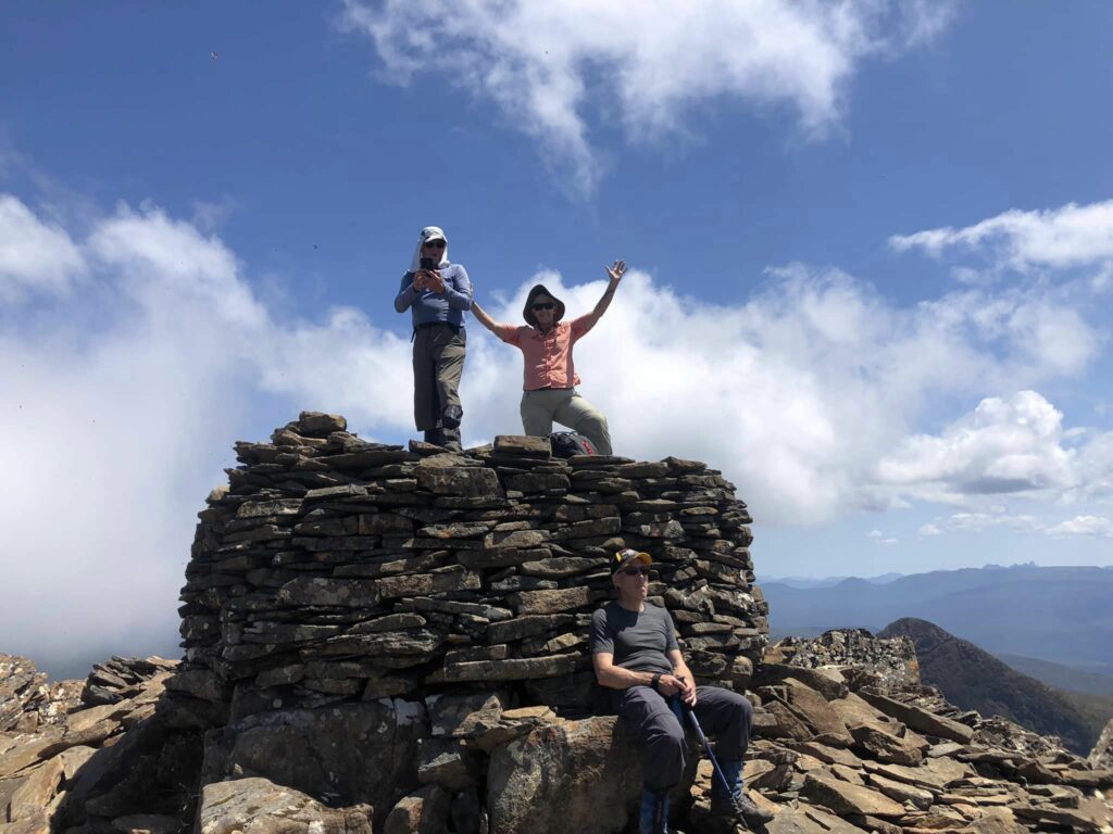 3 hikers on top of Adamson's Peak